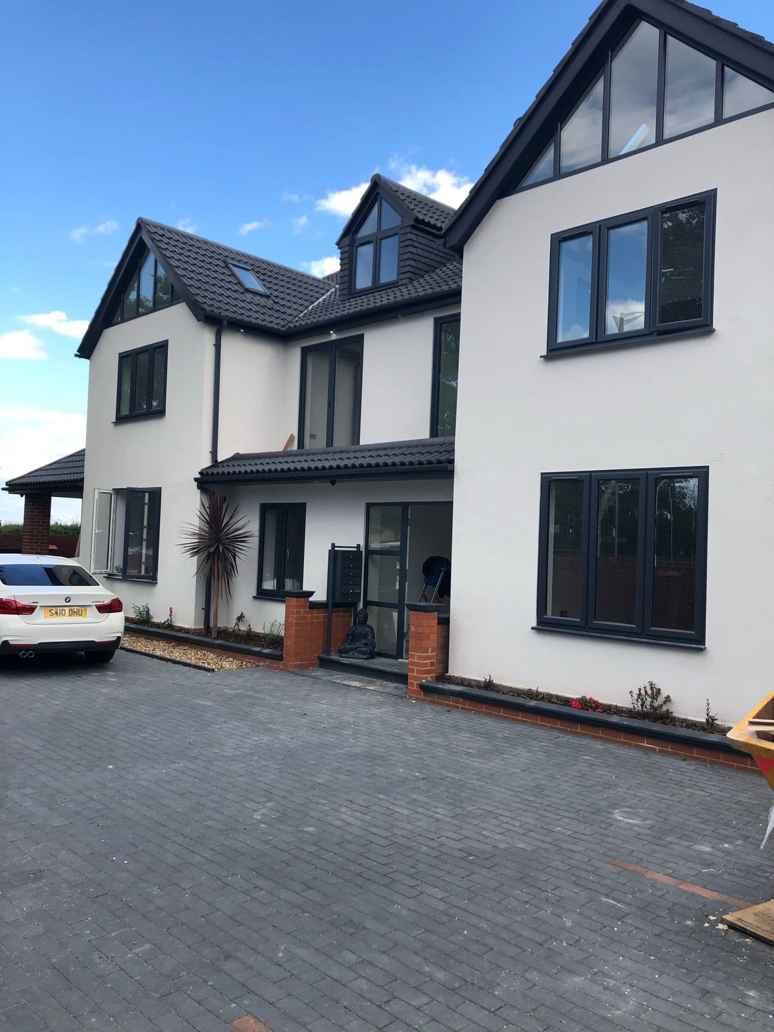 Modern new build home with full-height anthracite aluminium glazing meeting Future Homes Standard requirements