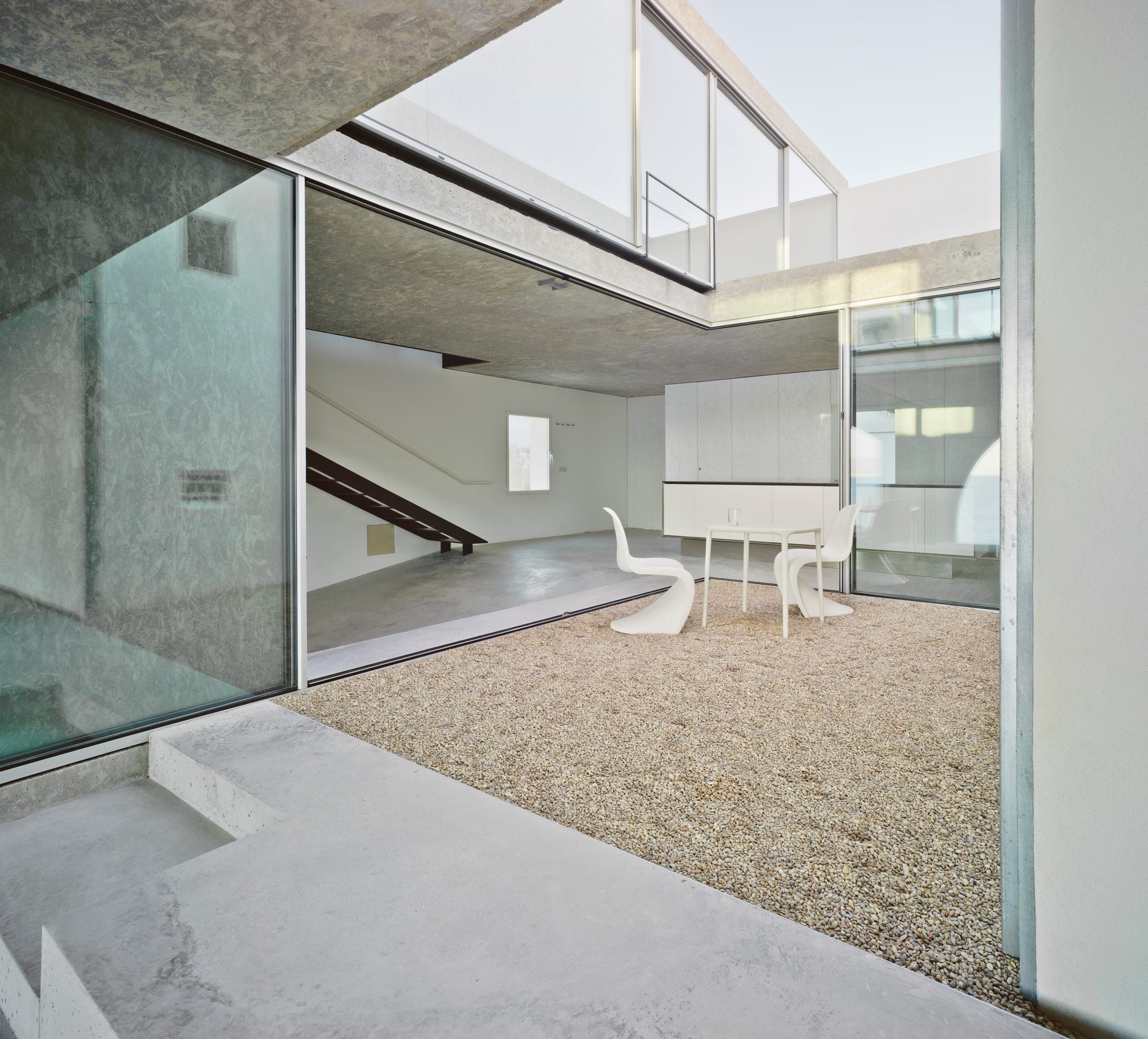 Cortizo double-height glass walls with courtyard view
