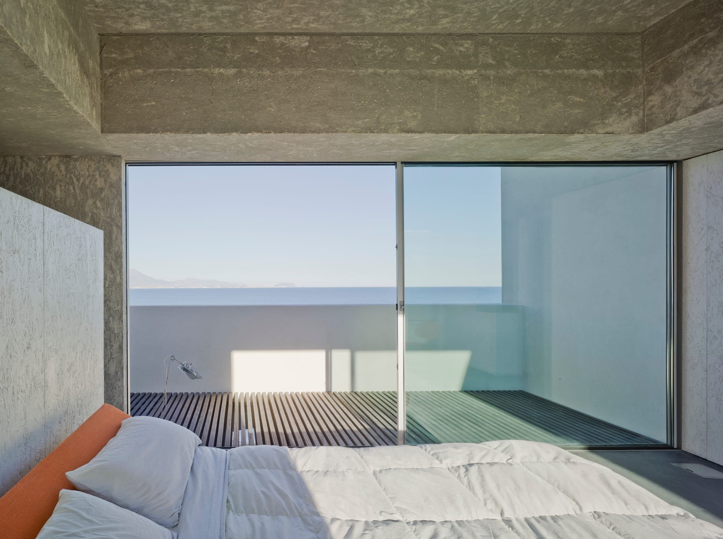 Cortizo aluminium sliding doors with sea view in minimalist bedroom