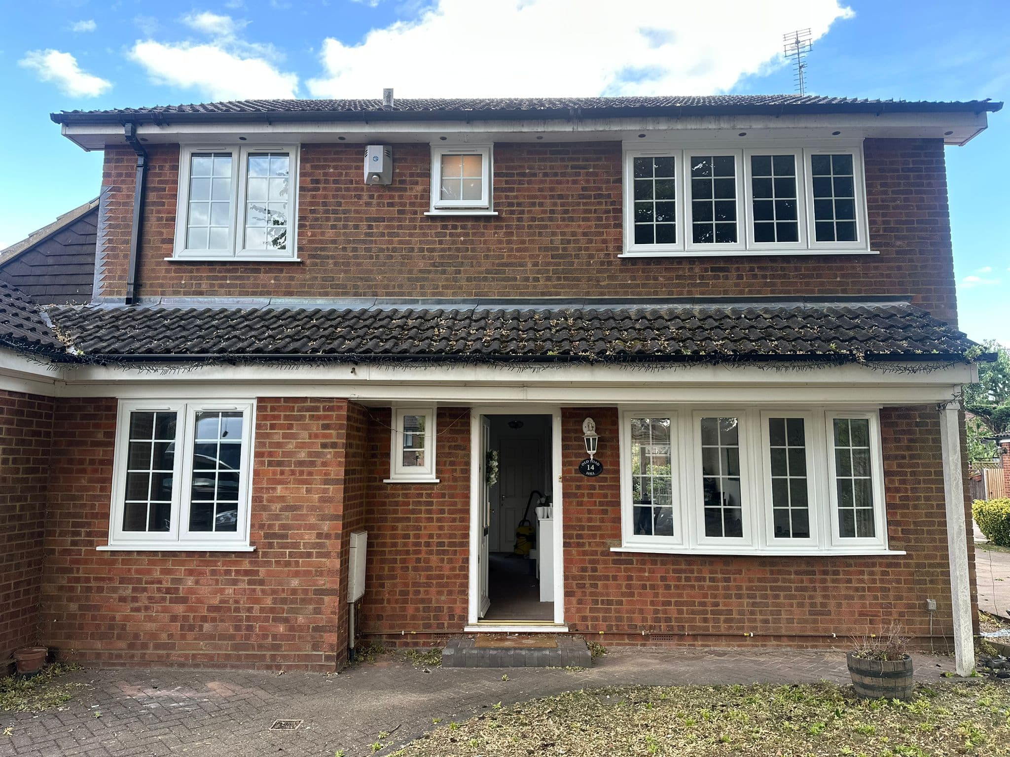 Full house installation of Rehau uPVC windows in white with anthracite grey sills