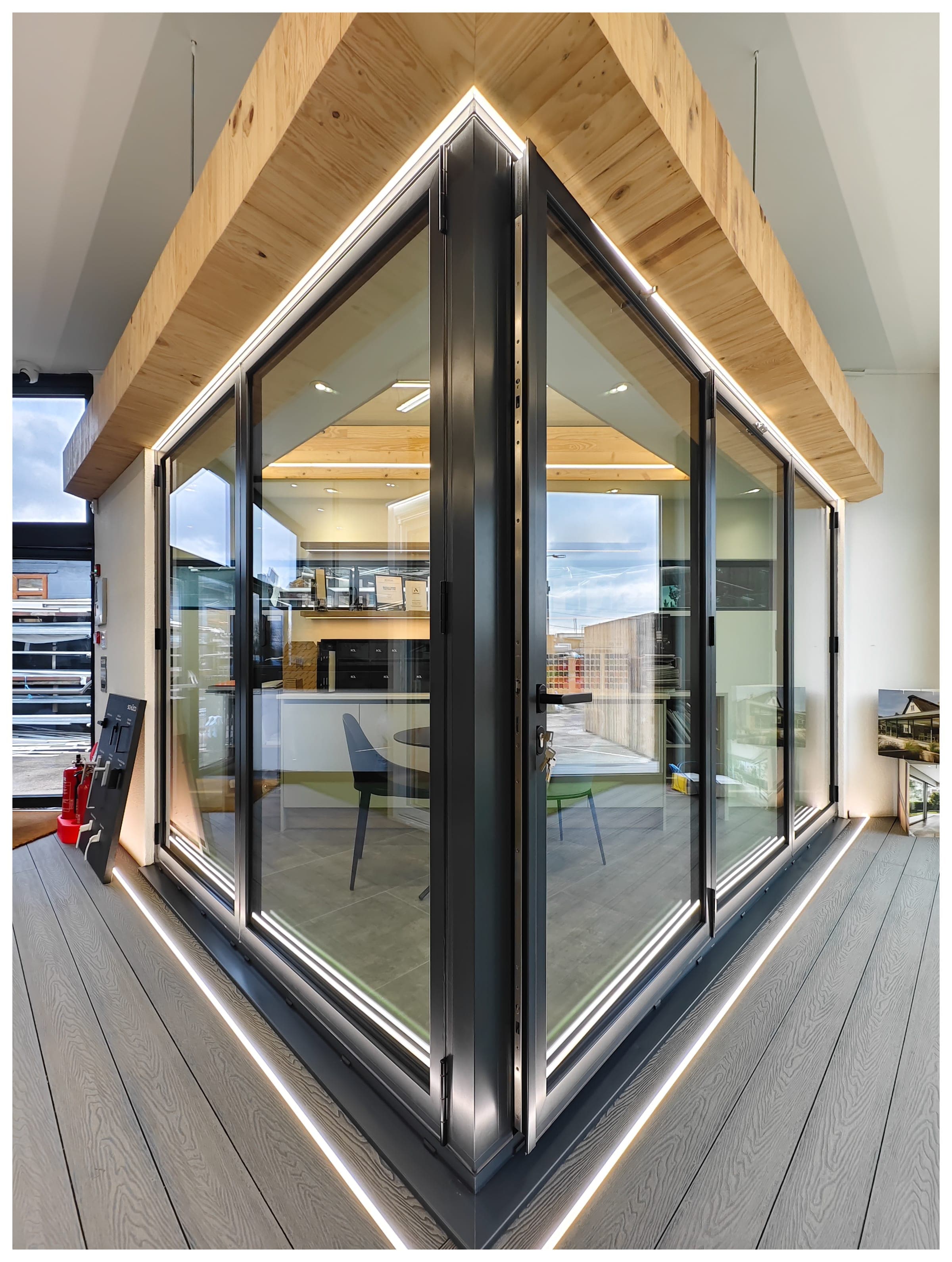 Aluminium bifold doors with apex feature and LED lighting in showroom
