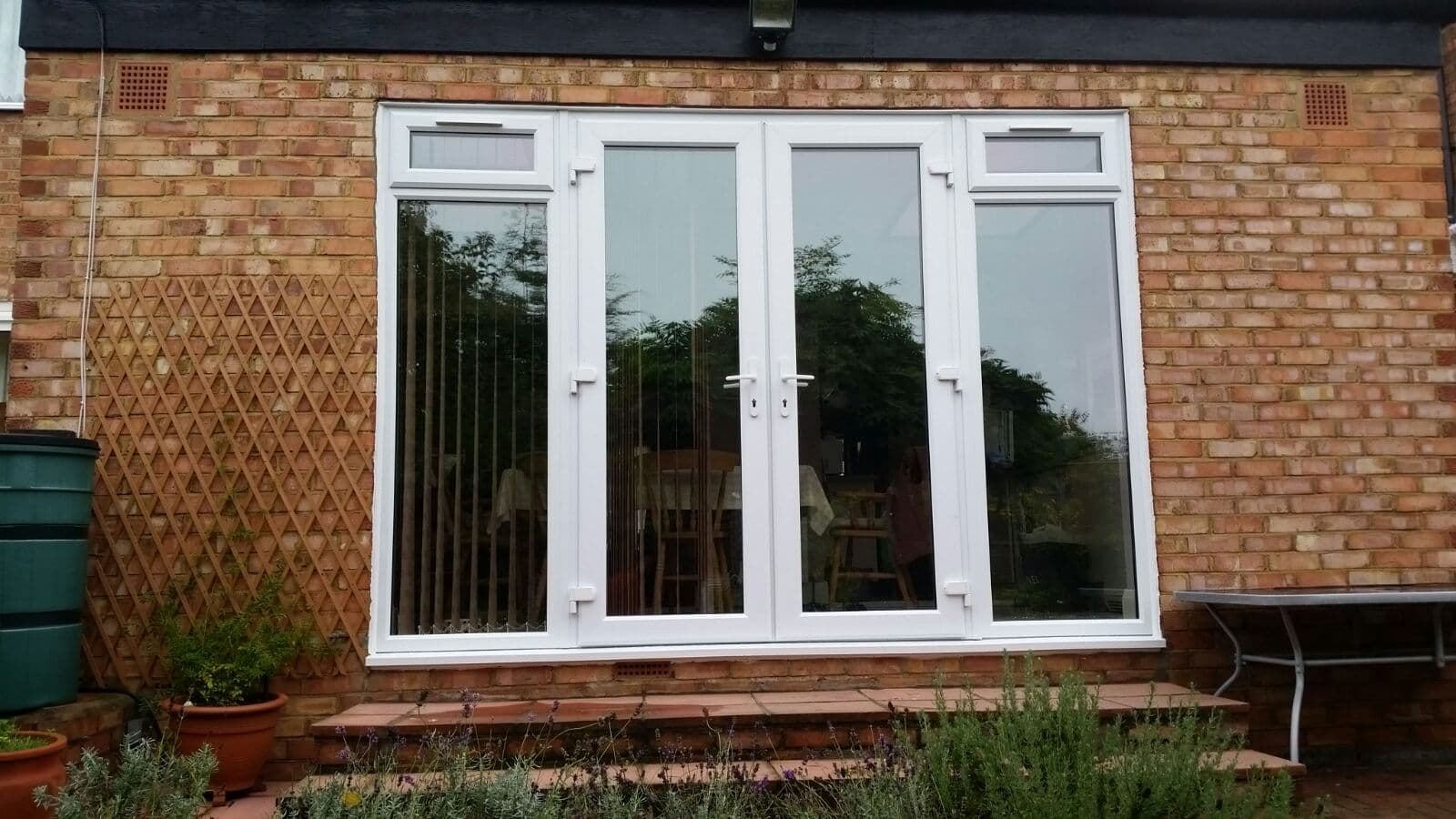 White patio doors with garden plants