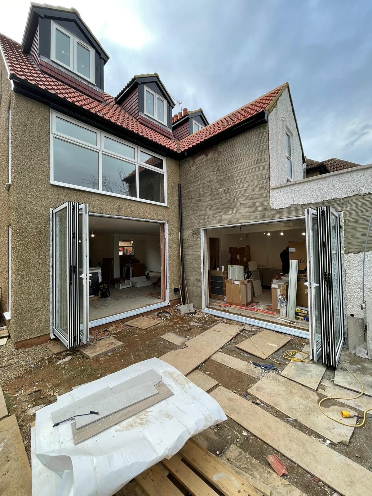 Aluminium bifold doors with casement windows on extension