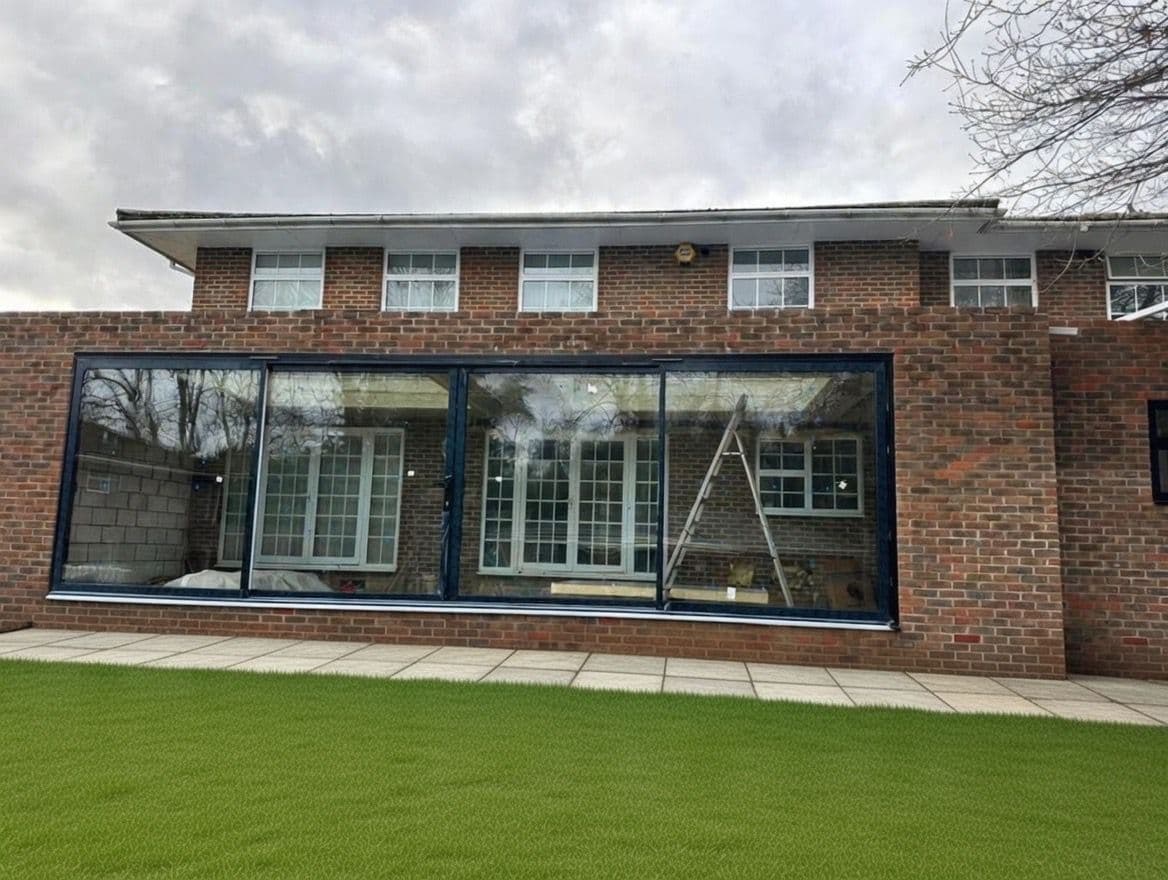 Cortizo aluminium sliding patio doors opening a UK rear extension onto the garden