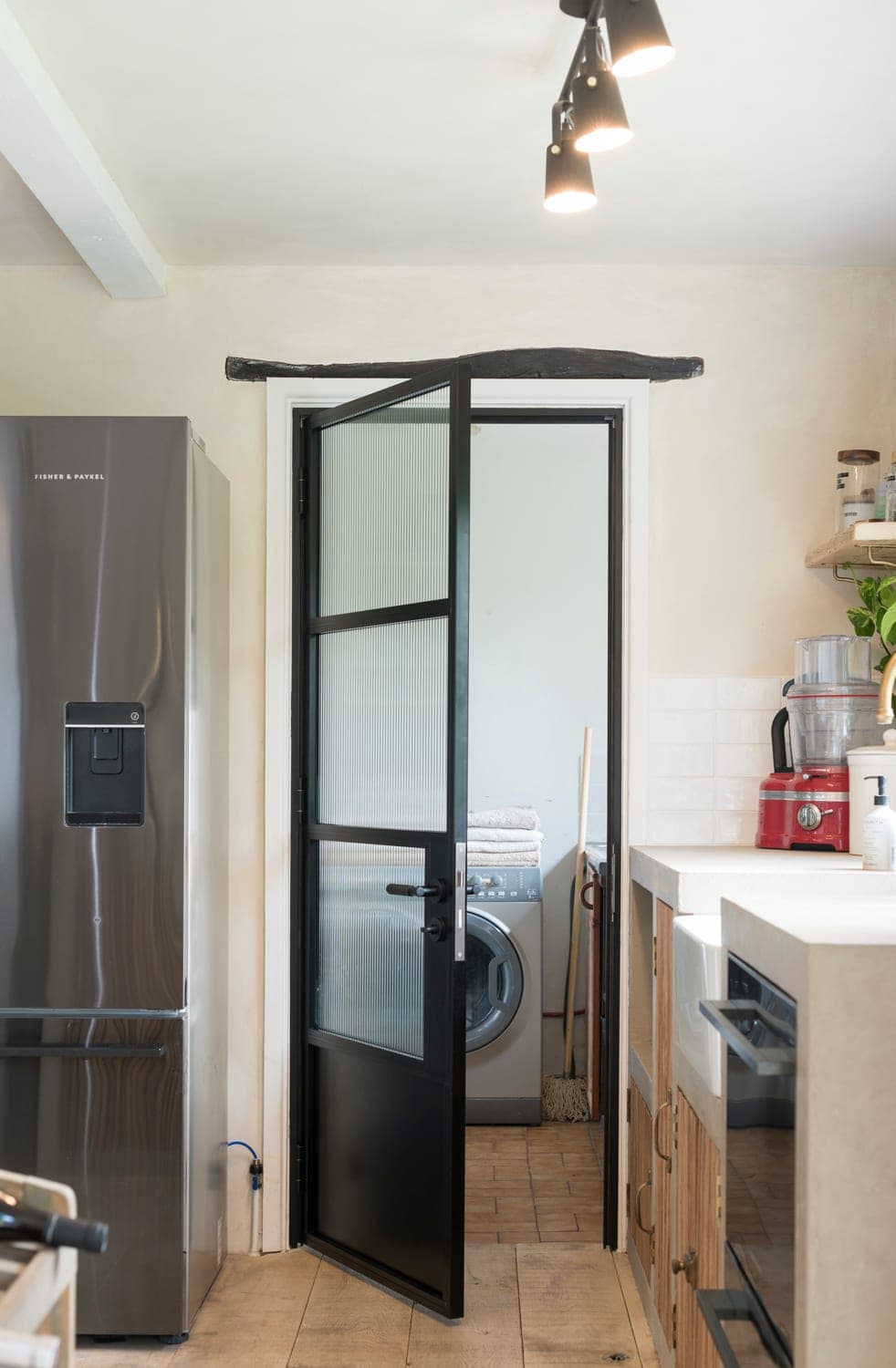 Origin OI-30 aluminium internal door used as a kitchen-to-dining room divider with appliances visible through glass