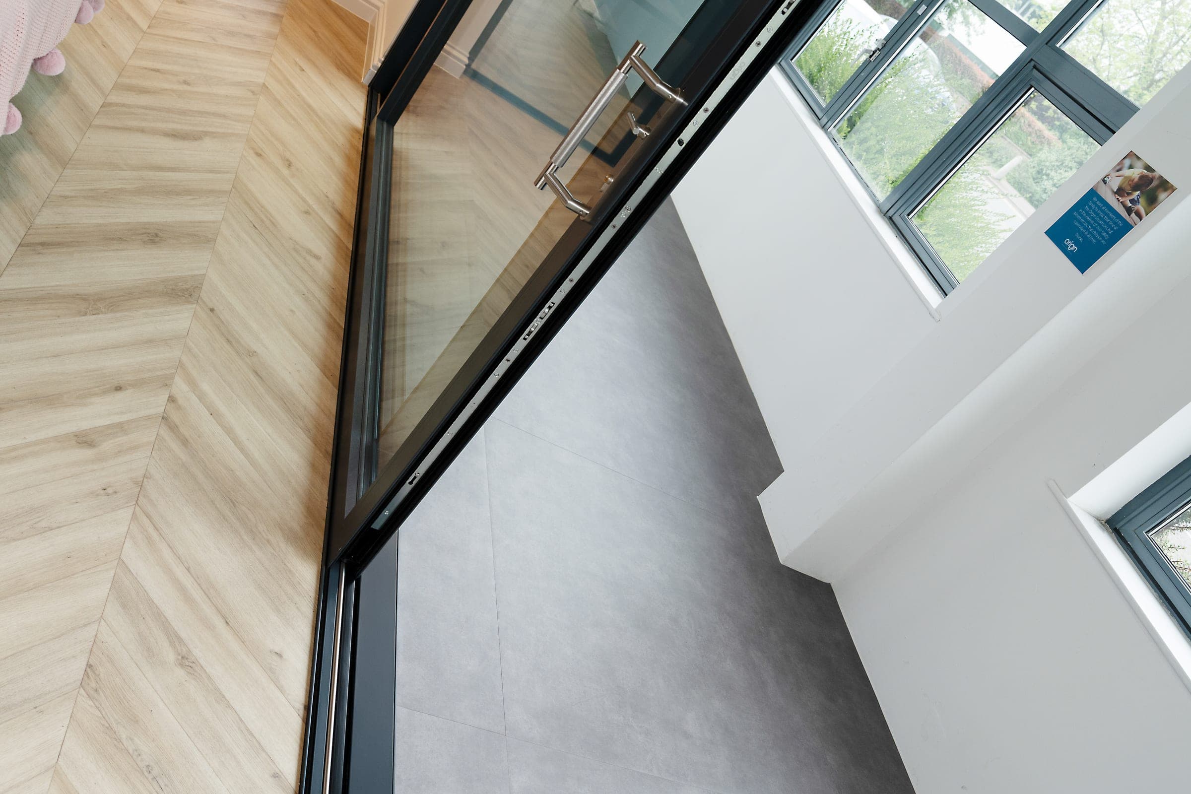 Origin OS-29+ aluminium sliding doors with concealed track detail, hardwood floor
