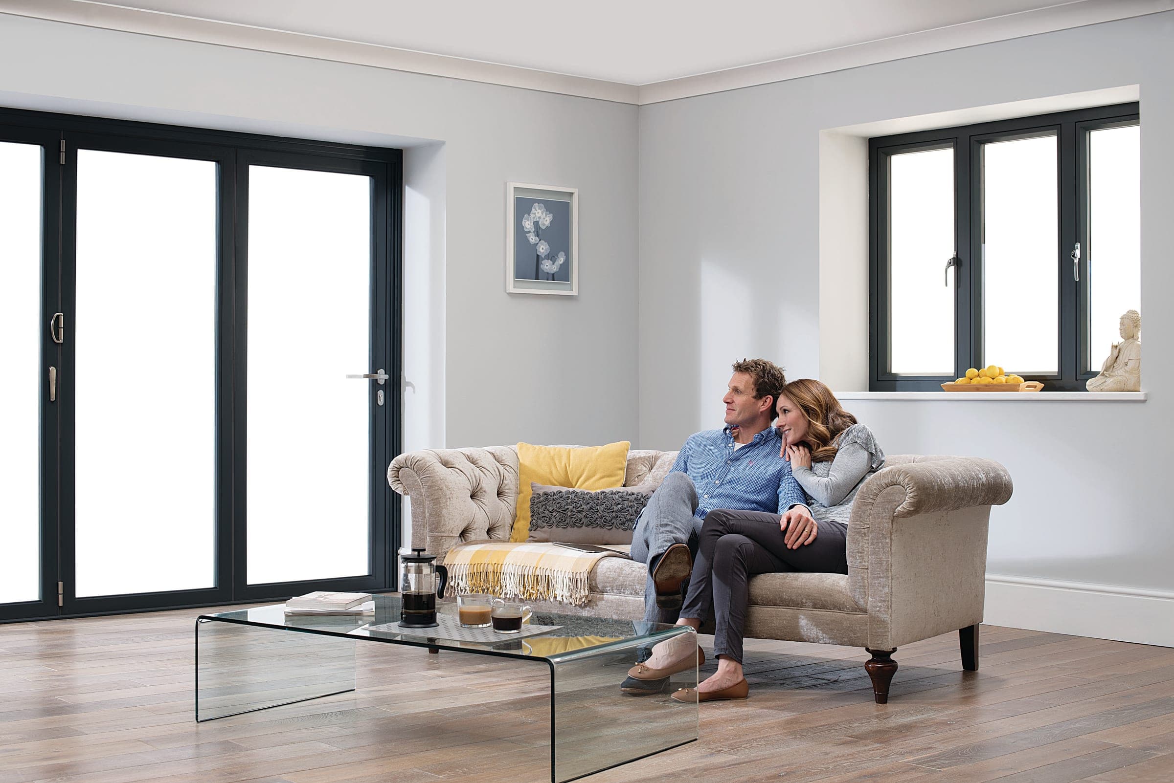 Origin OW-80 Premium aluminium casement windows with internal-and-external flush detail in a contemporary residential living room with couple seated